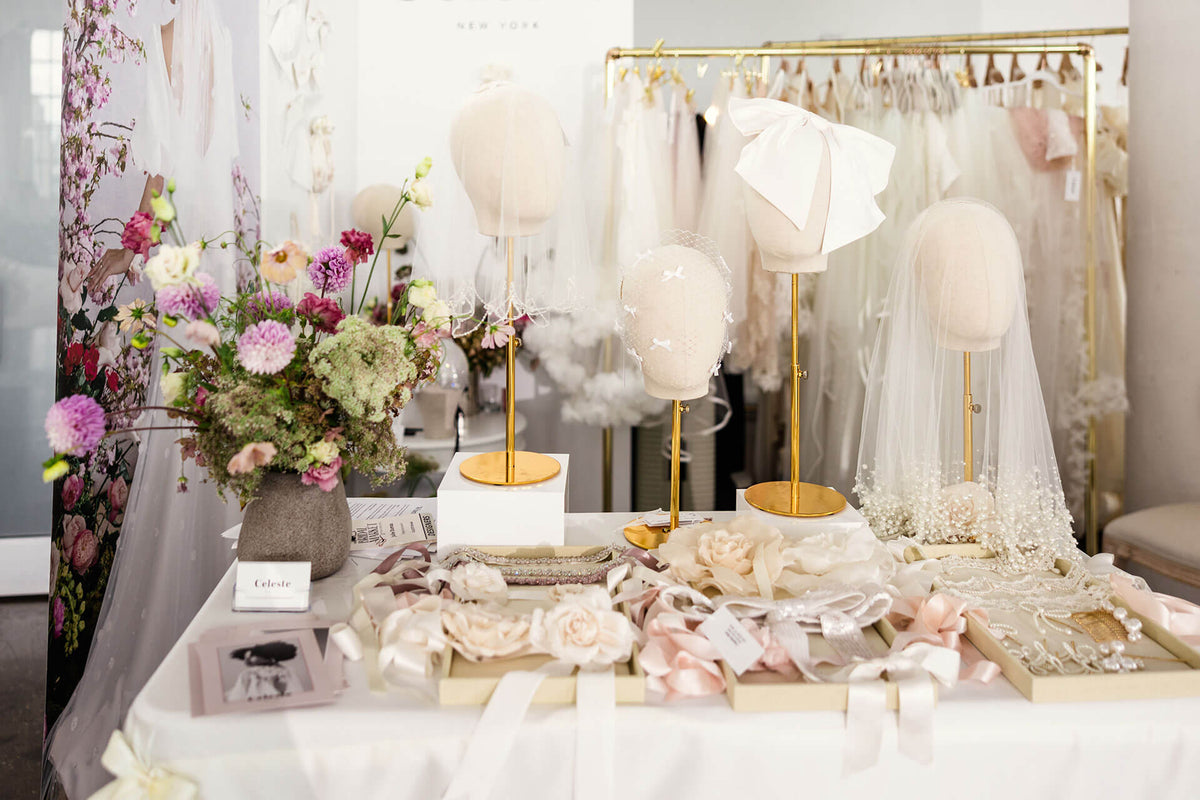 Wedding dress display with veils and flowers in a store setting