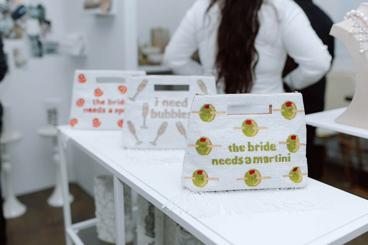 Three pouches with printed designs on a white surface, with a blurred background.
