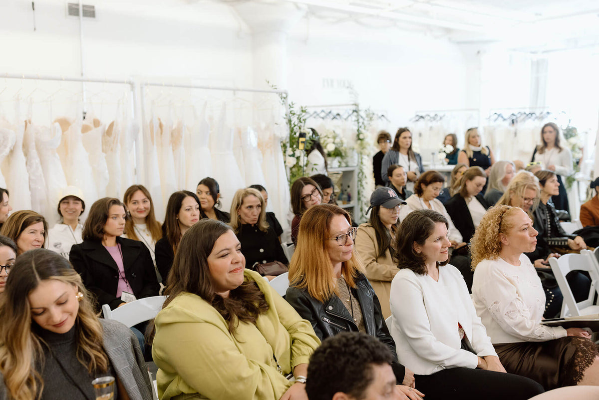 Bridal shop owners, bridal designers and boutique owners attending a presentation or event at the bridal market in new york